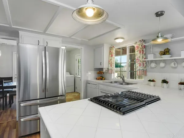 a kitchen with a stove a sink and a refrigerator