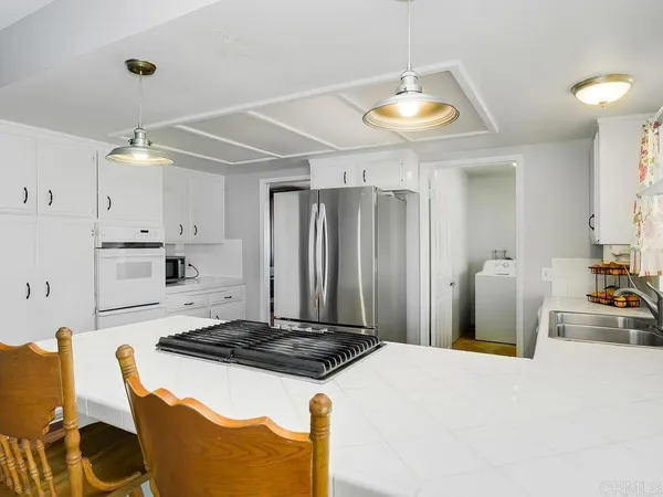 a kitchen with a stove and a refrigerator