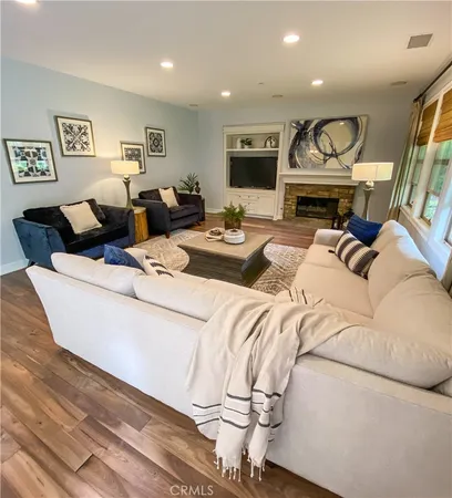 a living room with furniture a fireplace and a flat screen tv