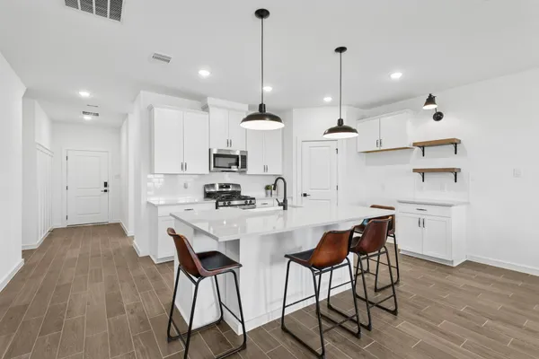 a kitchen that has a sink and a stove top oven