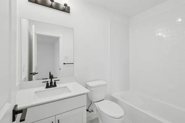 a view of a bathroom with a sink and mirror