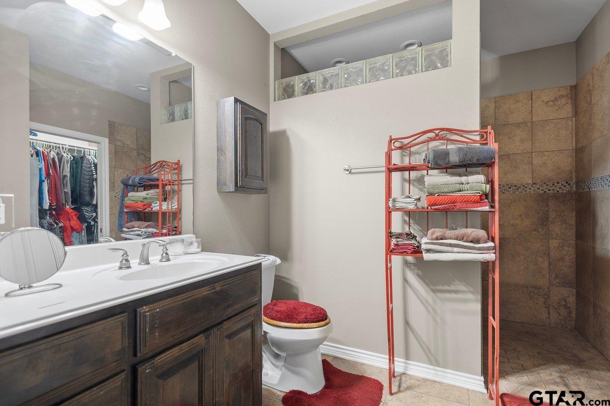 2801 Valley View Street Tyler, TX 75701 - Photo 13 of 14 a bathroom with a sink vanity mirror and toilet