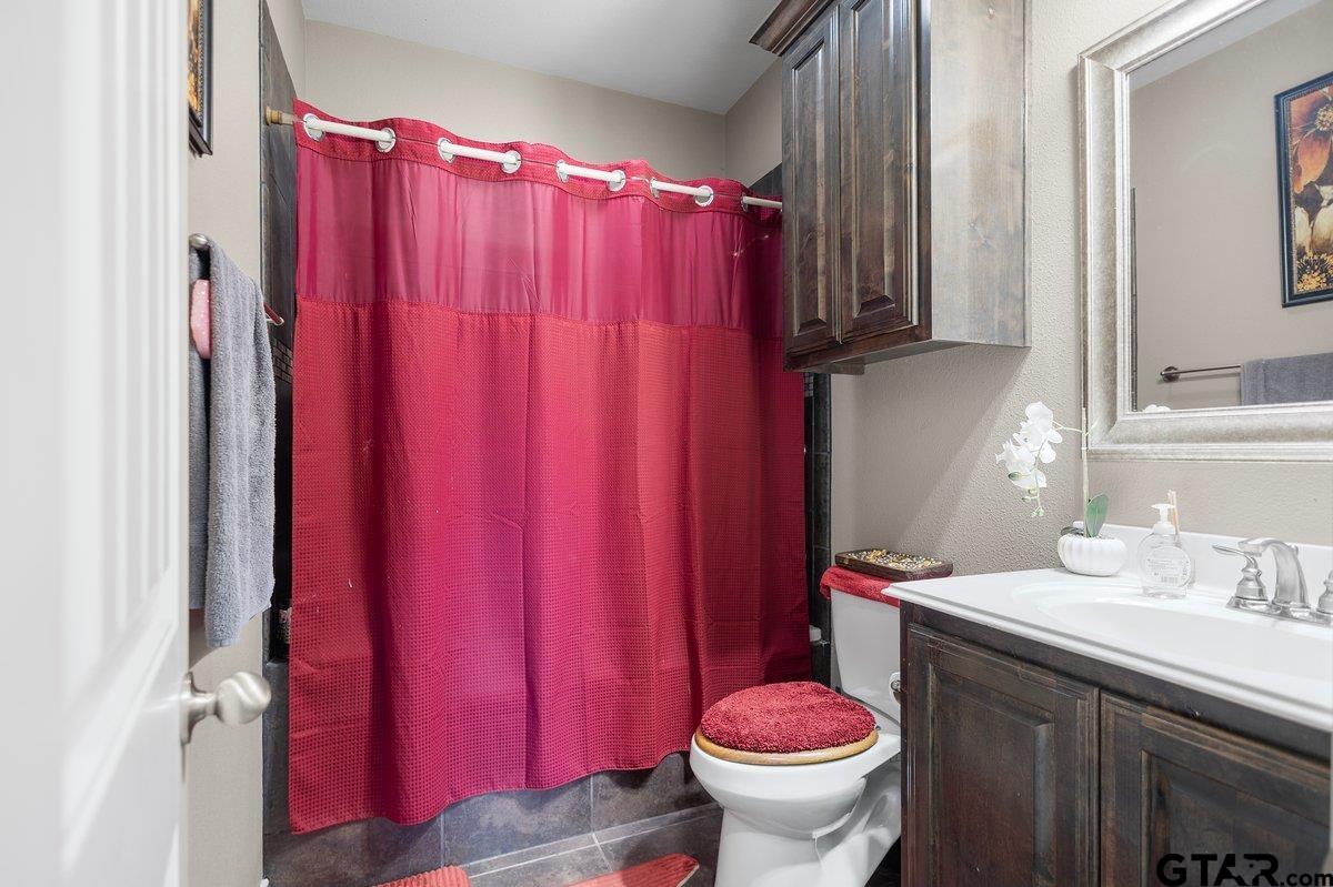 2801 Valley View Street Tyler, TX 75701 - Photo 14 of 14 a bathroom with a sink toilet and shower curtain