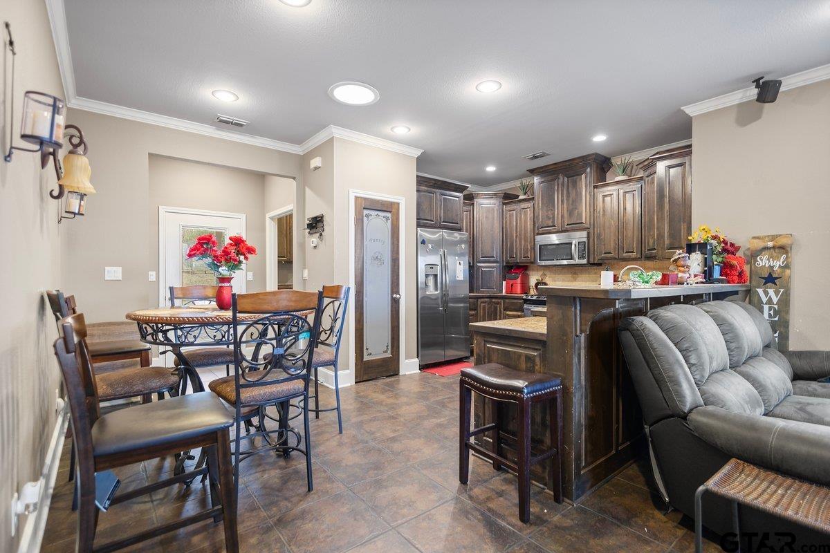 2801 Valley View Street Tyler, TX 75701 - Photo 8 of 14 a outdoor dining space with furniture a chandelier and kitchen view