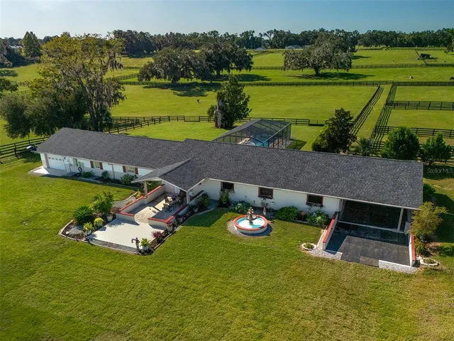 an aerial view of a house with garden space and lake view