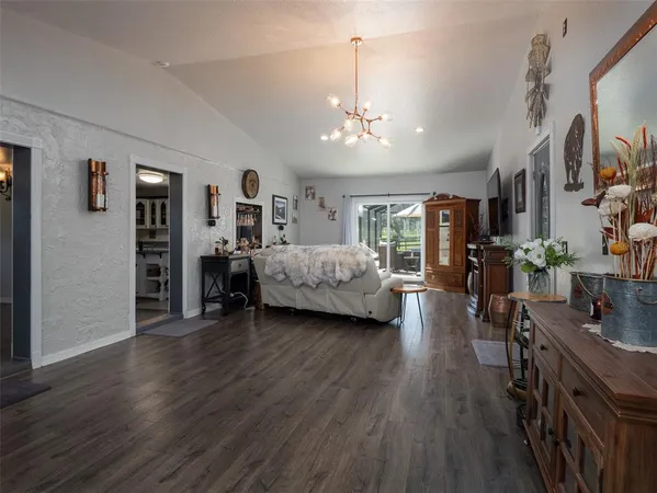 a living room with furniture a fireplace a flat screen tv and a large window