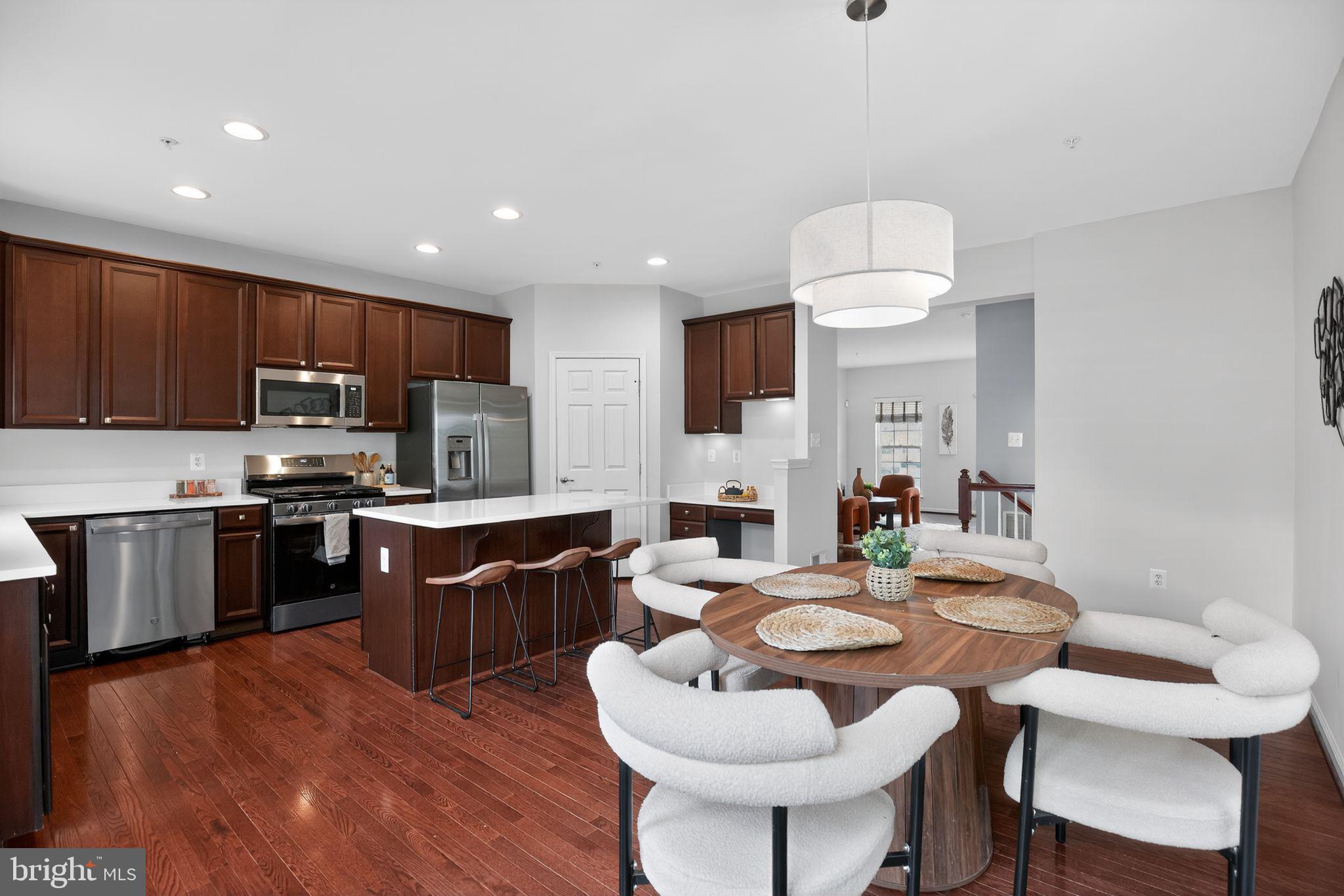 2624 St Marys View Road Accokeek, MD 20607 - Photo 12 of 31 a kitchen with a dining table chairs sink and stove