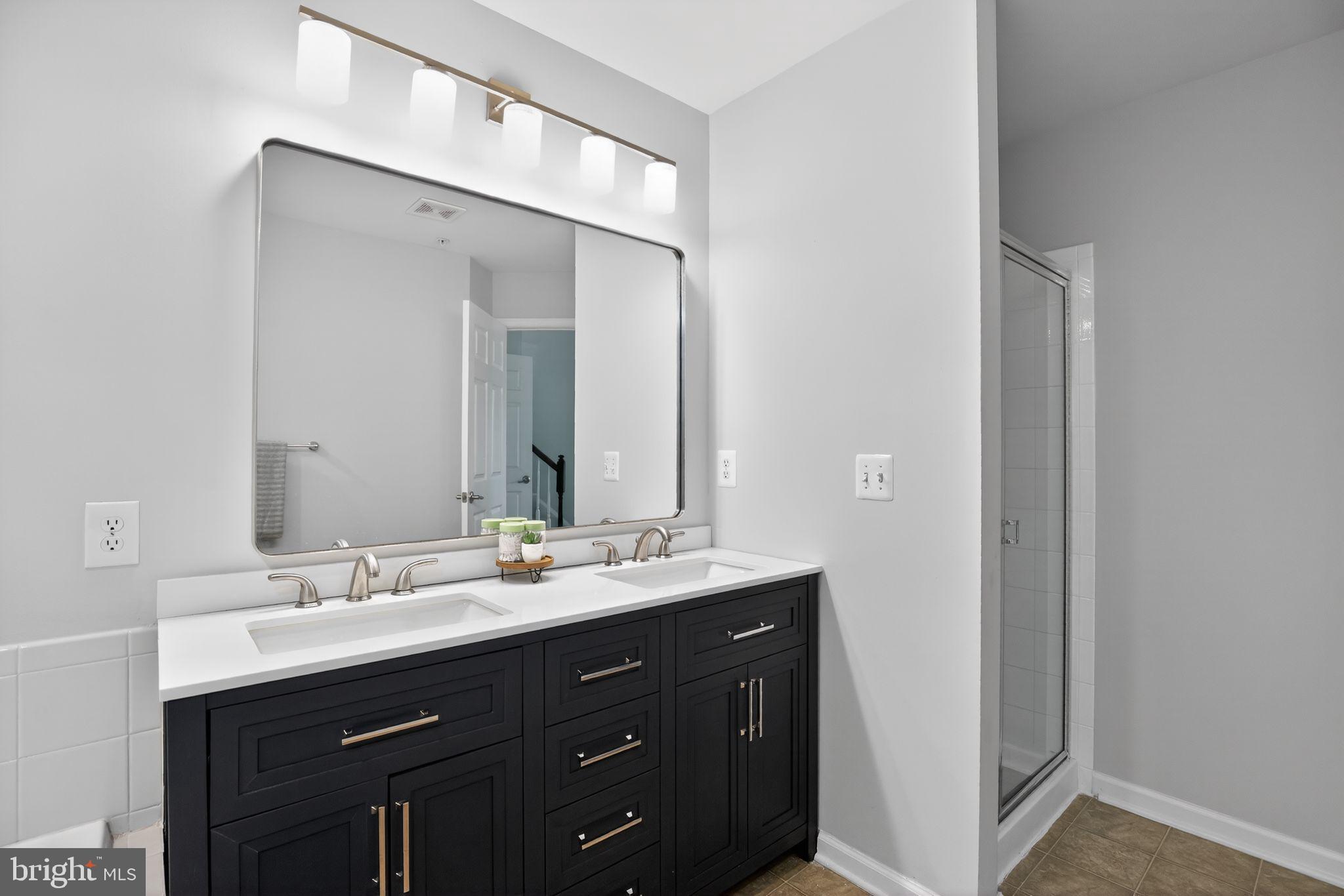 2624 St Marys View Road Accokeek, MD 20607 - Photo 19 of 31 a bathroom with a double vanity sink and mirror
