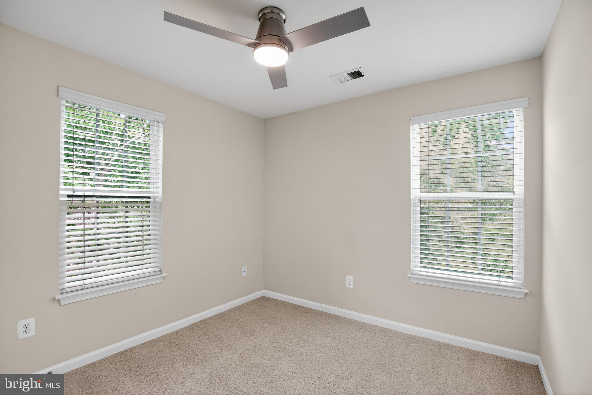 2624 St Marys View Road Accokeek, MD 20607 - Photo 22 of 31 a view of an empty room with a window and a ceiling fan