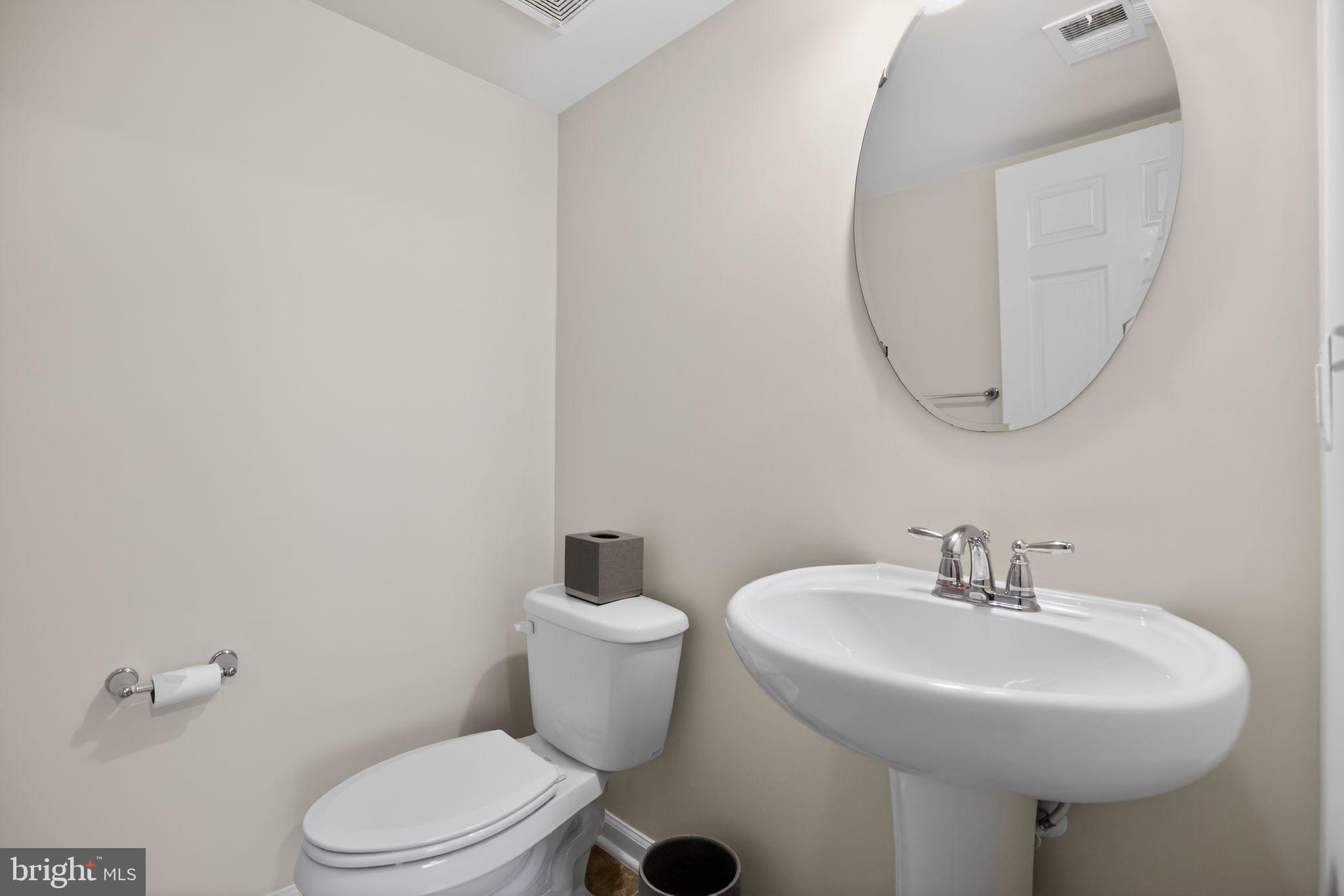 2624 St Marys View Road Accokeek, MD 20607 - Photo 23 of 31 a bathroom with a sink a mirror and a toilet