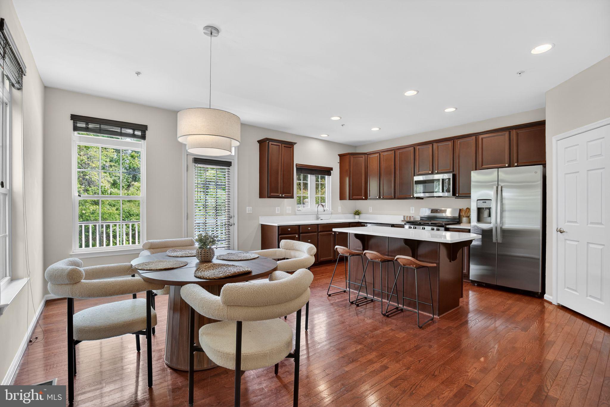 2624 St Marys View Road Accokeek, MD 20607 - Photo 6 of 31 a kitchen with granite countertop a stove a sink a dining table and chairs