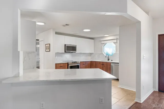 a kitchen with a window a sink and a stove