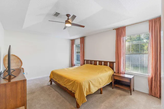 a bathroom with a granite countertop sink a toilet and a mirror