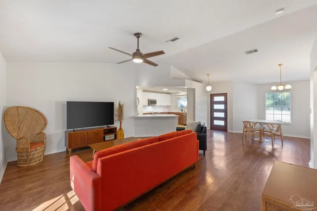 a view of a dining room with furniture and wooden floor