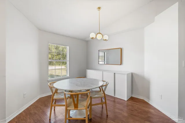 a large kitchen with stainless steel appliances a large counter top a stove and a refrigerator