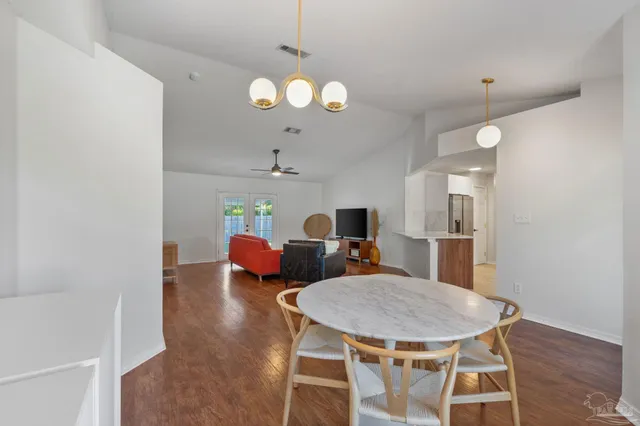 a kitchen with stainless steel appliances granite countertop a sink dishwasher stove and microwave with wooden cabinets