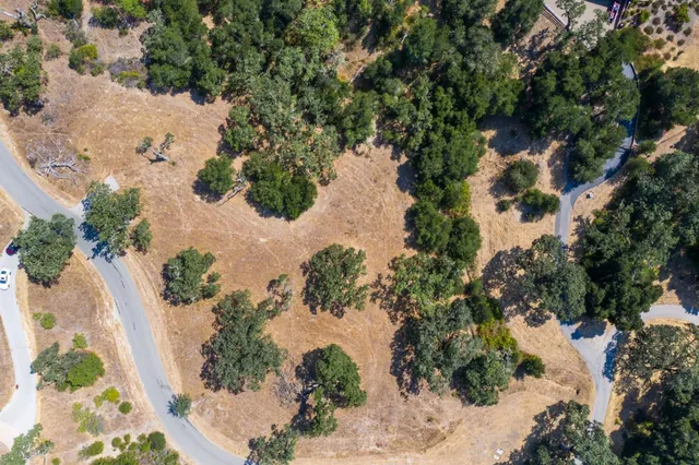 an aerial view of a houses with yard