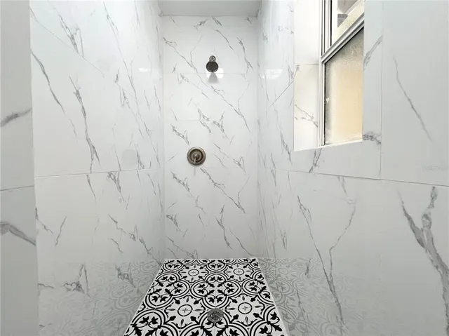 a bathroom with a granite countertop toilet sink and mirror