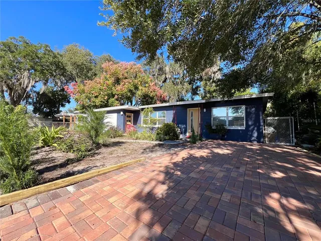 a view of a house with a tree in the background