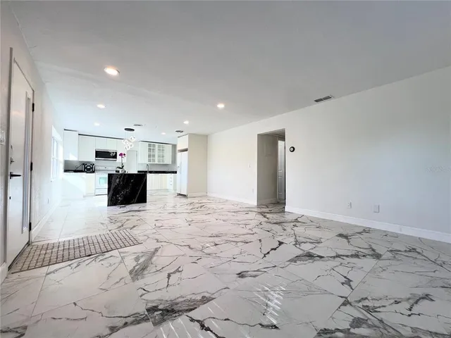a kitchen with stainless steel appliances kitchen island granite countertop a sink and cabinets
