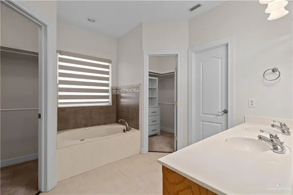 a bathroom with a bathtub and a sink