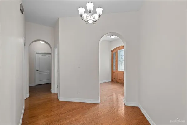 a view of a room with wooden floor