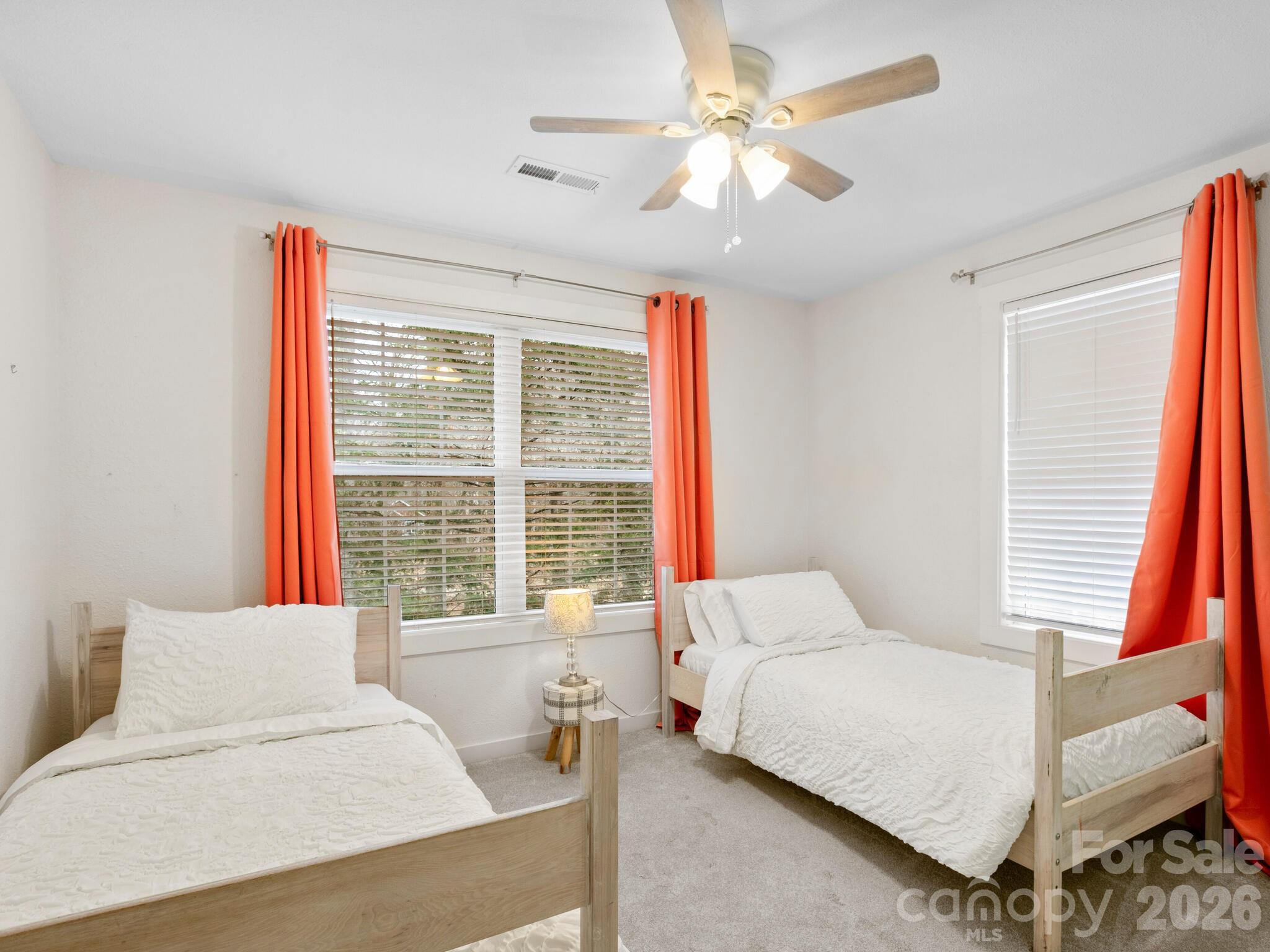 10 Bear Trail Fairview, NC 28730 - Photo 22 of 29 a bedroom with a large bed and a chandelier