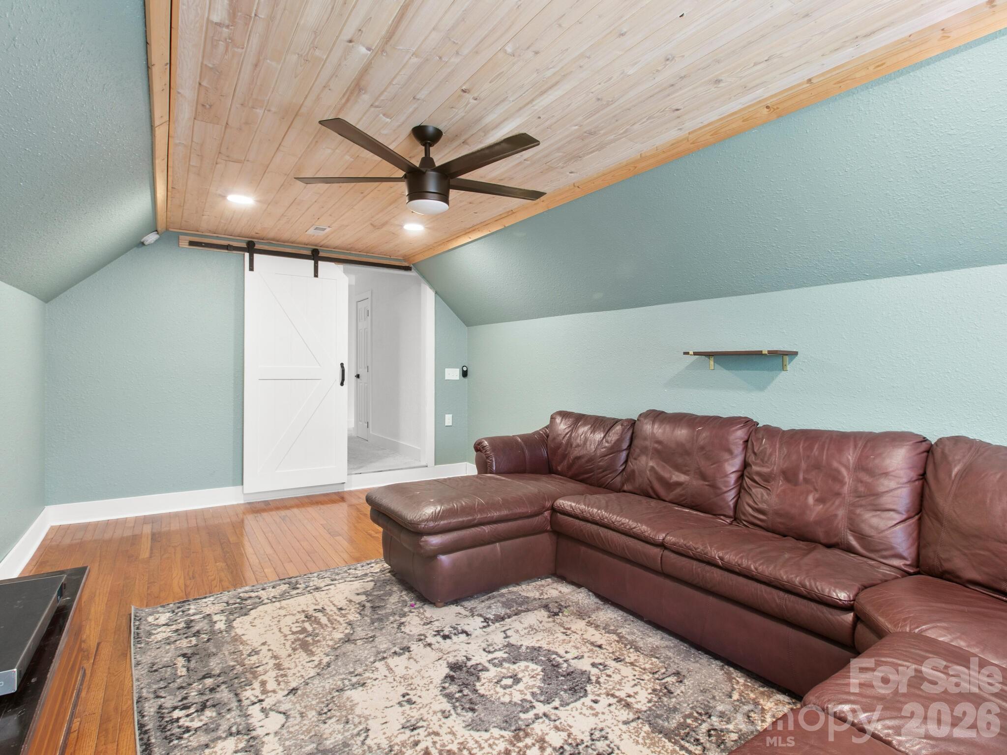 10 Bear Trail Fairview, NC 28730 - Photo 24 of 29 a living room with a couch and a ceiling fan