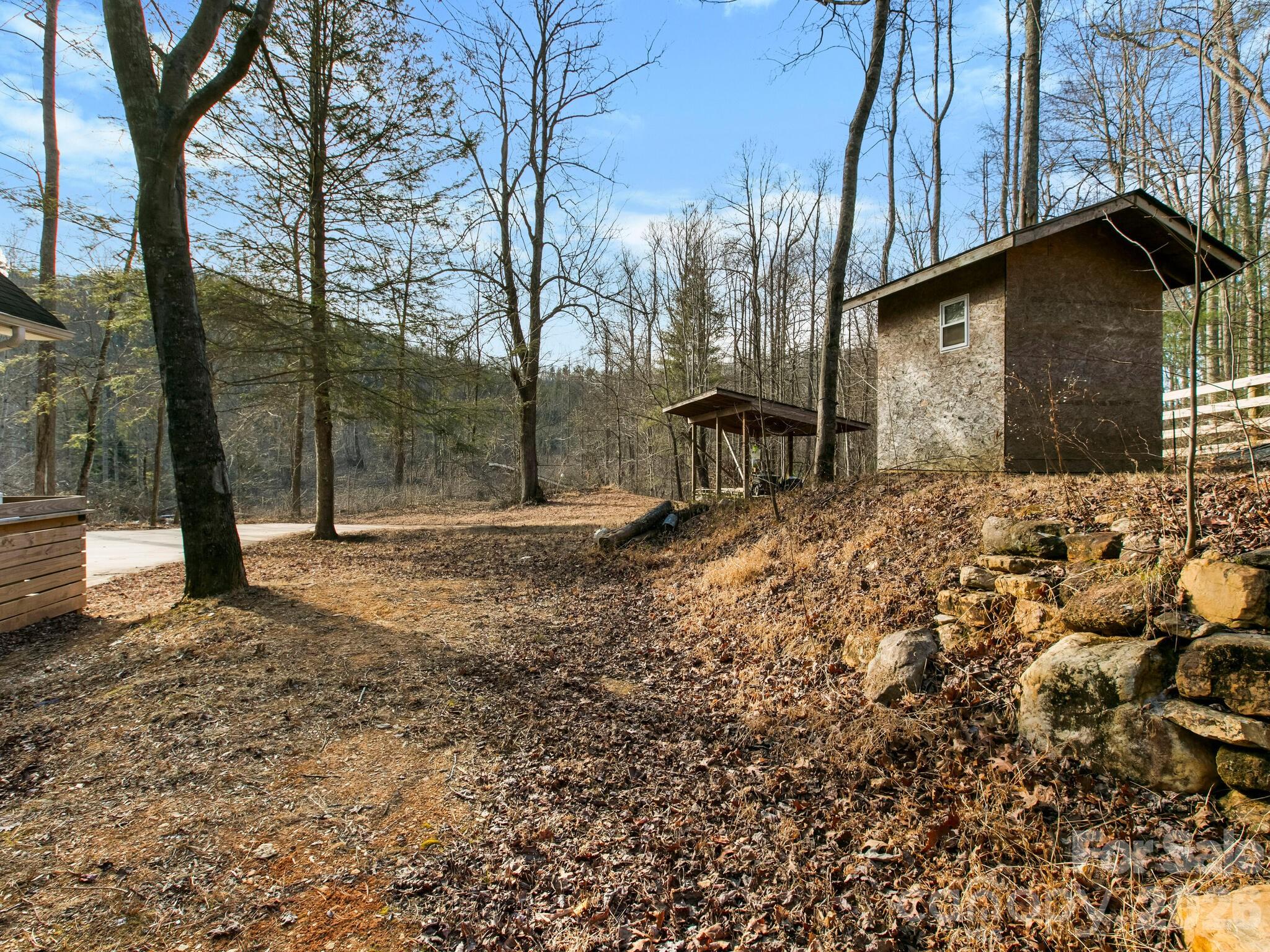 10 Bear Trail Fairview, NC 28730 - Photo 28 of 29 a view of backyard with large trees and wooden fence
