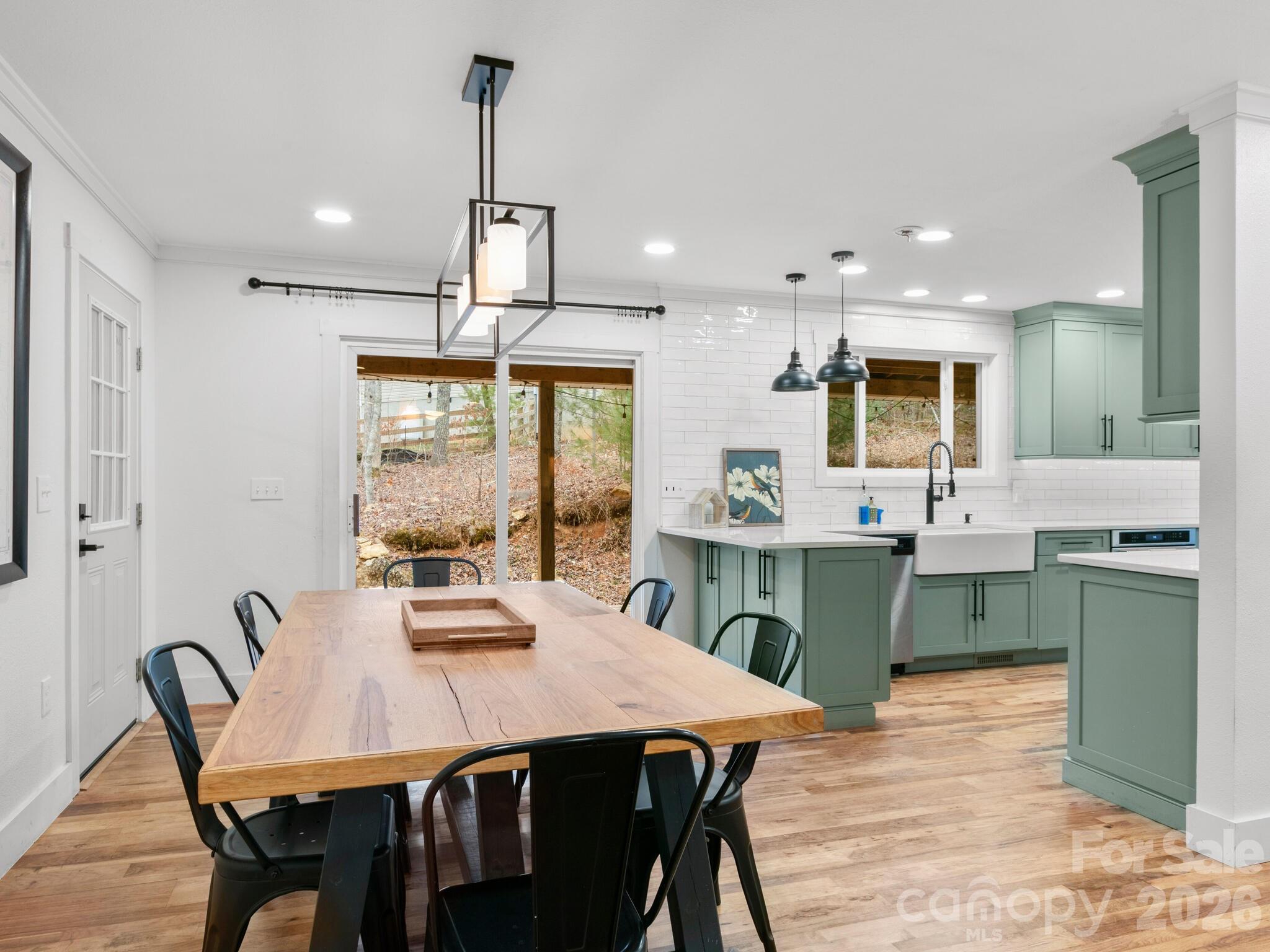 10 Bear Trail Fairview, NC 28730 - Photo 6 of 29 a kitchen with stainless steel appliances kitchen island granite countertop a dining table chairs and sink