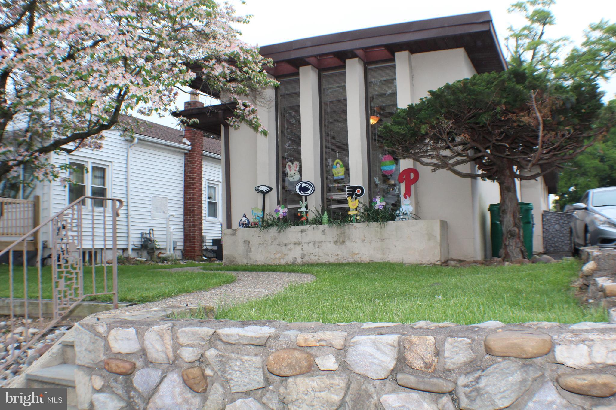 Exterior front with stone wall and stairs