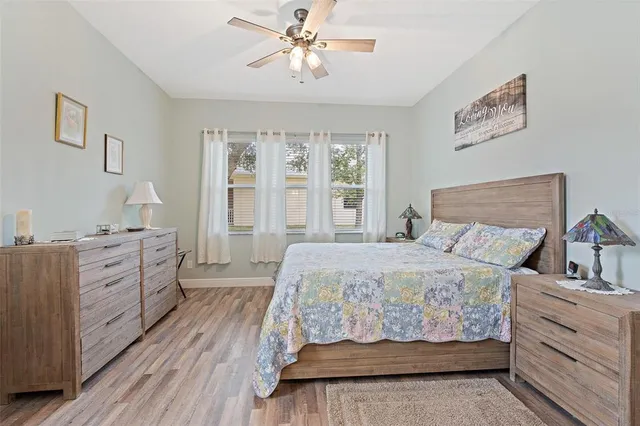 a bedroom with a bed and large windows
