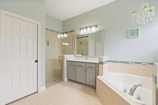 a bathroom with a tub a sink and mirrors