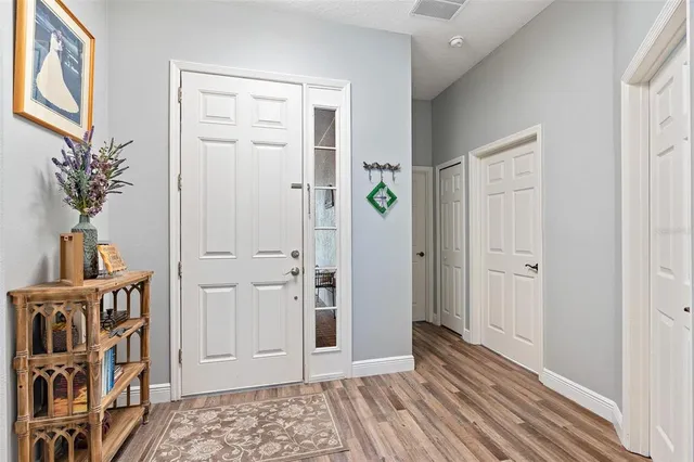 a view of a bedroom with wooden floor and closet