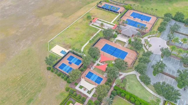 a view of swimming pool with trees in front of it