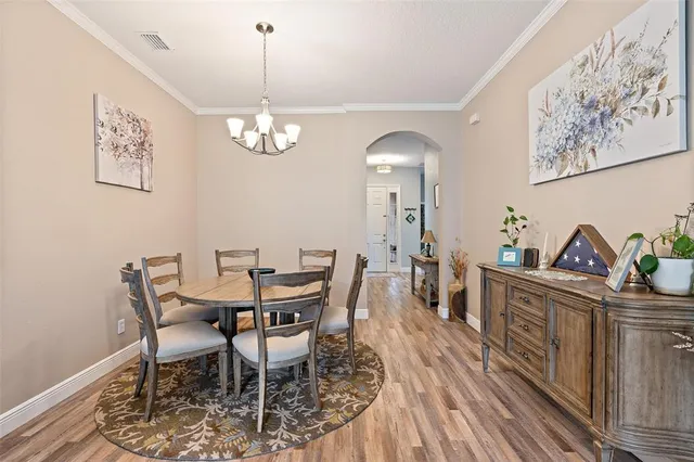 a view of a dining room with furniture wooden floor and a chandelier