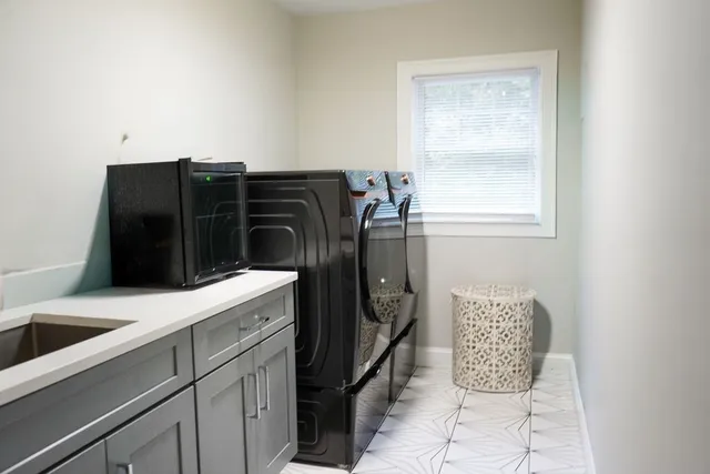 a white bath tub sitting next to a white sink