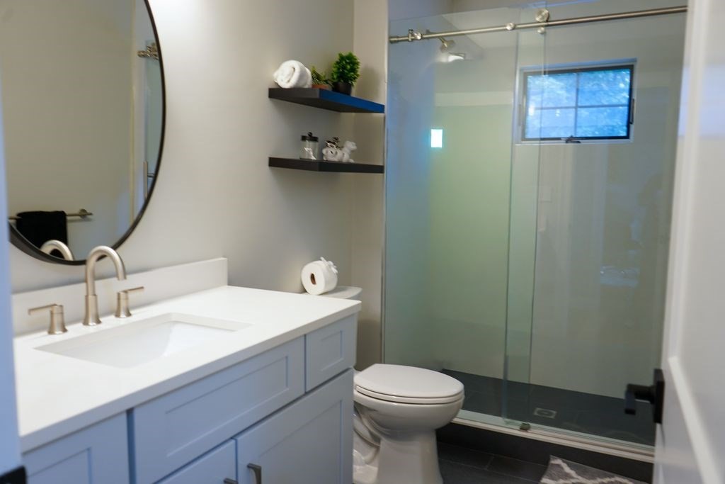 242 Valley Road Needham, MA 02492 - Photo 19 of 24 a bathroom with a sink a toilet and shower
