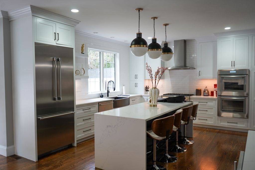242 Valley Road Needham, MA 02492 - Photo 2 of 24 a kitchen with stainless steel appliances granite countertop a sink a stove and a refrigerator