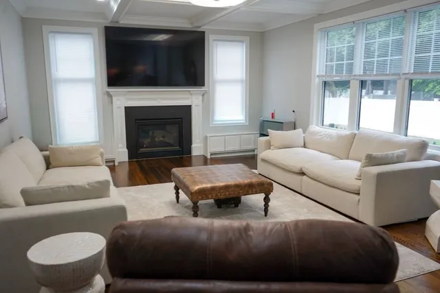 a living room with furniture flat screen tv and a fireplace