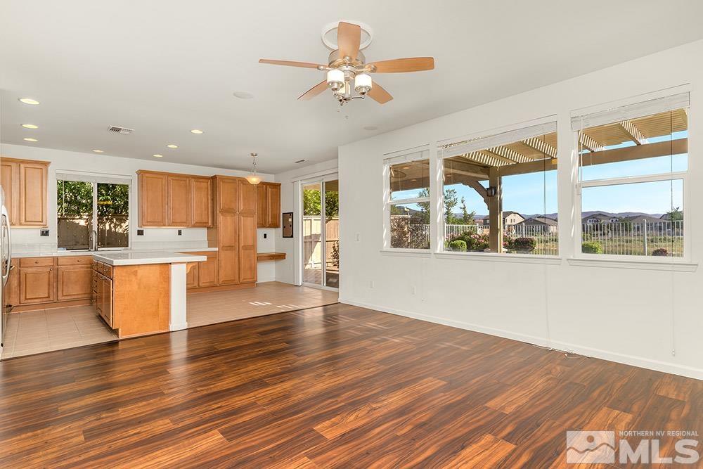 10691 Fire Poppy Circle Reno, NV 89521 - Photo 8 of 28 a view of an empty room with window and wooden floor