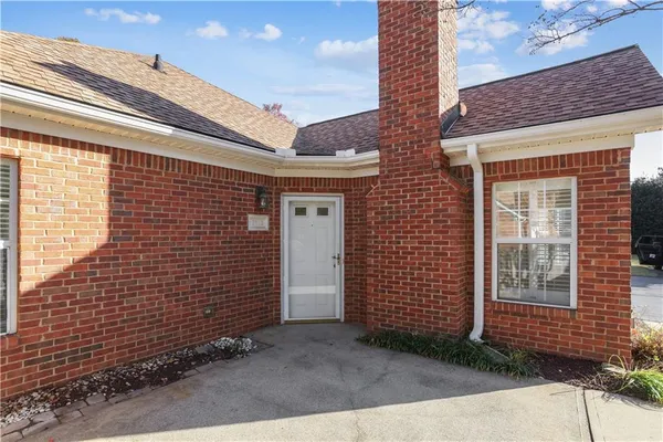 a view of a brick house with many windows