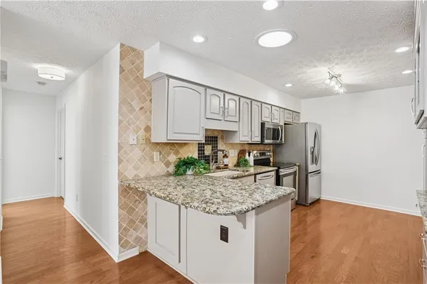 a kitchen with a refrigerator and countertop
