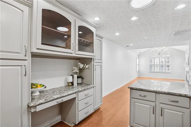 a kitchen with granite countertop cabinets stainless steel appliances and a counter space