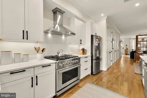 a kitchen with stainless steel appliances a stove a sink and a refrigerator