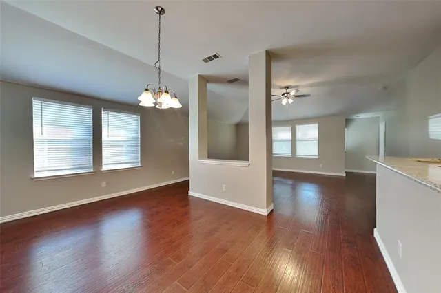 a view of a room with wooden floor and large windows