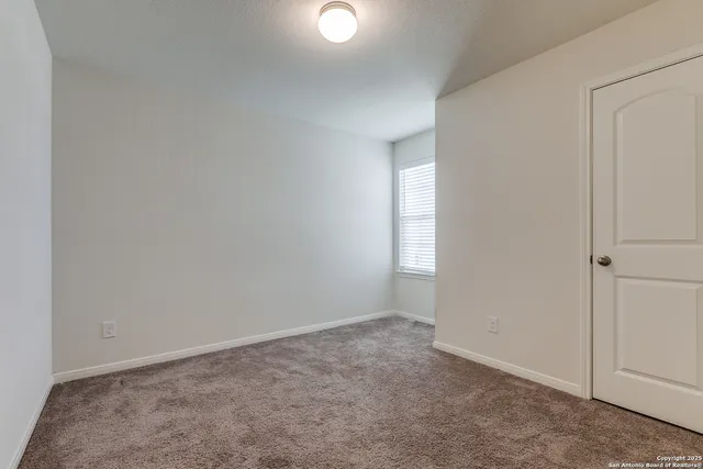 a view of an empty room and closet area