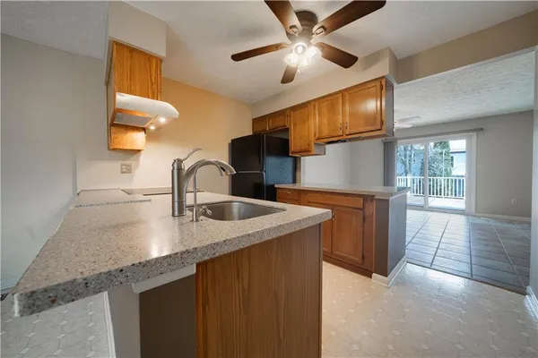 a kitchen with stainless steel appliances granite countertop a sink a stove and a microwave oven