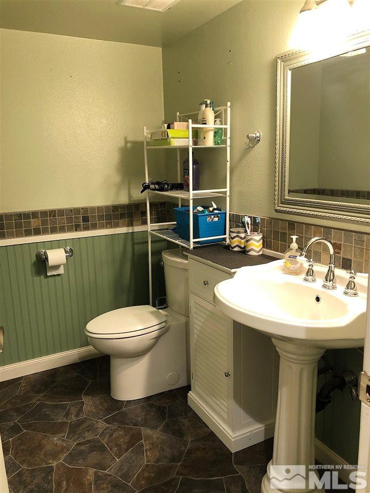 2180 Figoni Ranch Road, Unit NV Sparks, NV 89434 - Photo 16 of 39 a bathroom with a sink toilet and mirror