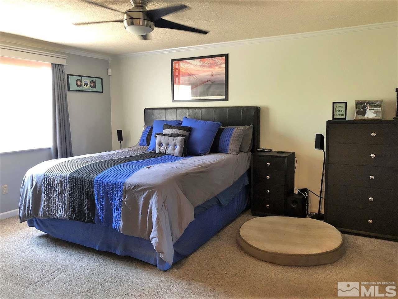 2180 Figoni Ranch Road, Unit NV Sparks, NV 89434 - Photo 18 of 39 a bedroom with a bed and a painting on the wall